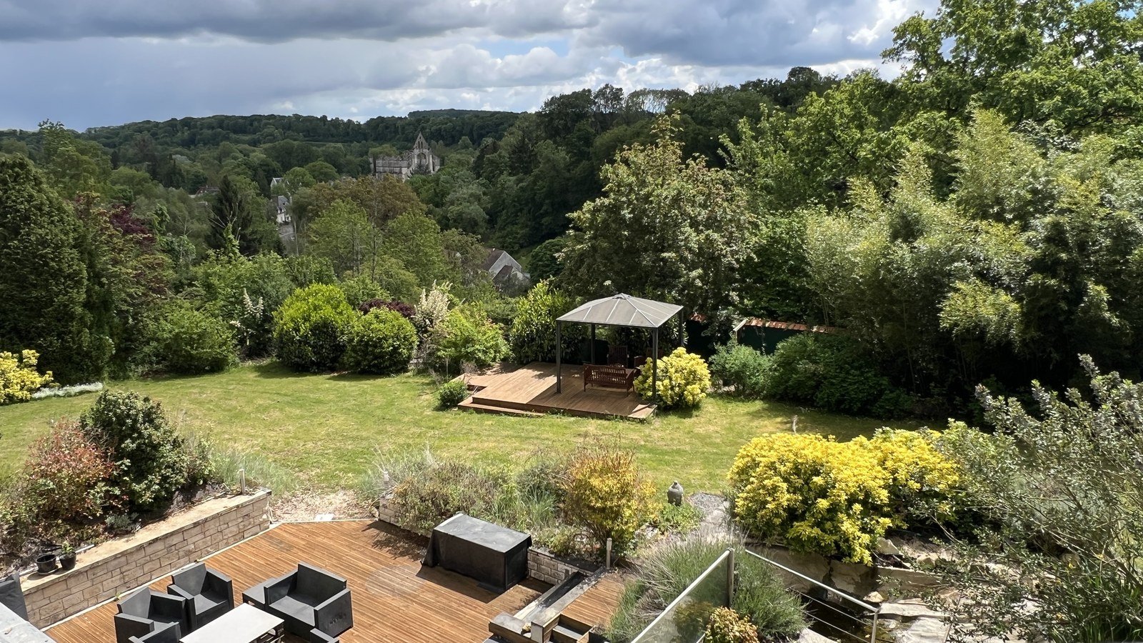 Panoramic garden view toward Longpont abbey from the property terrace
